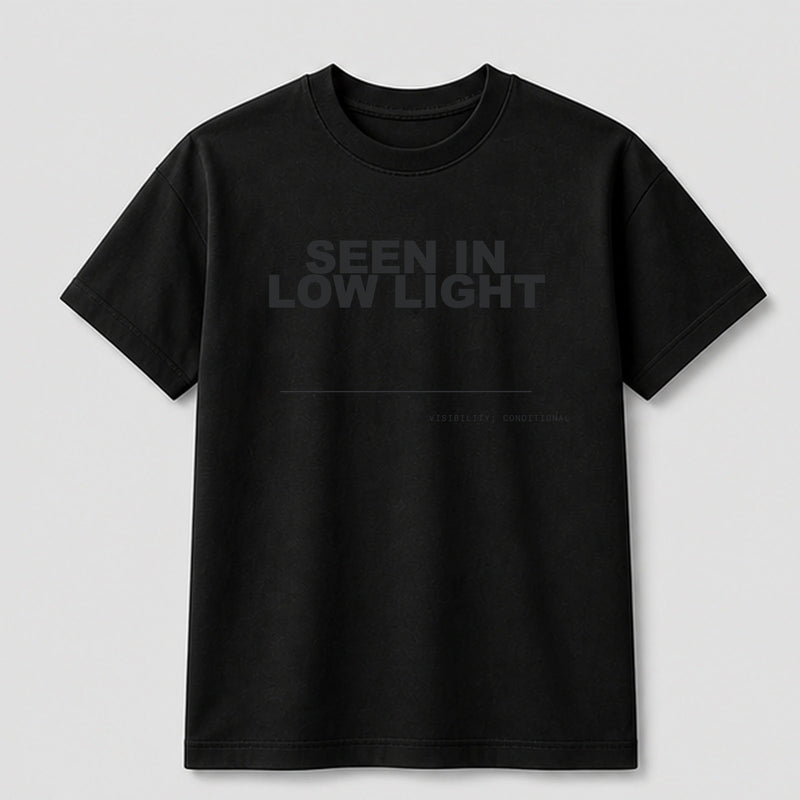 Seen In Low Light graphic tee by Threadmates featuring original minimal graphic artwork on black t-shirt, front.